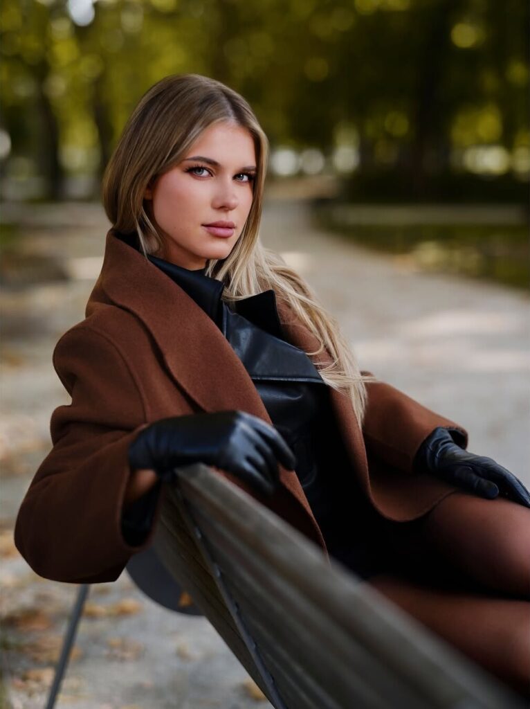 Autumn outdoor lifestyle portrait of a woman on a park bench by ShotsByDeen