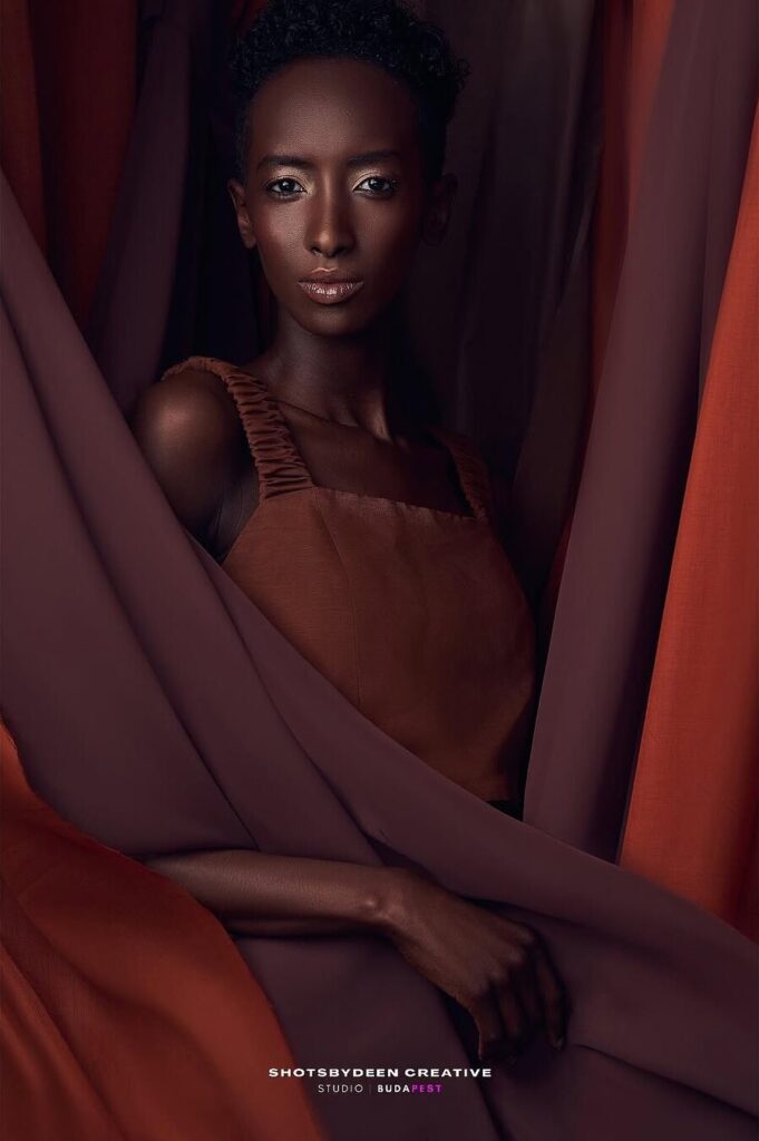 Editorial studio portrait with red drapery by ShotsByDeen